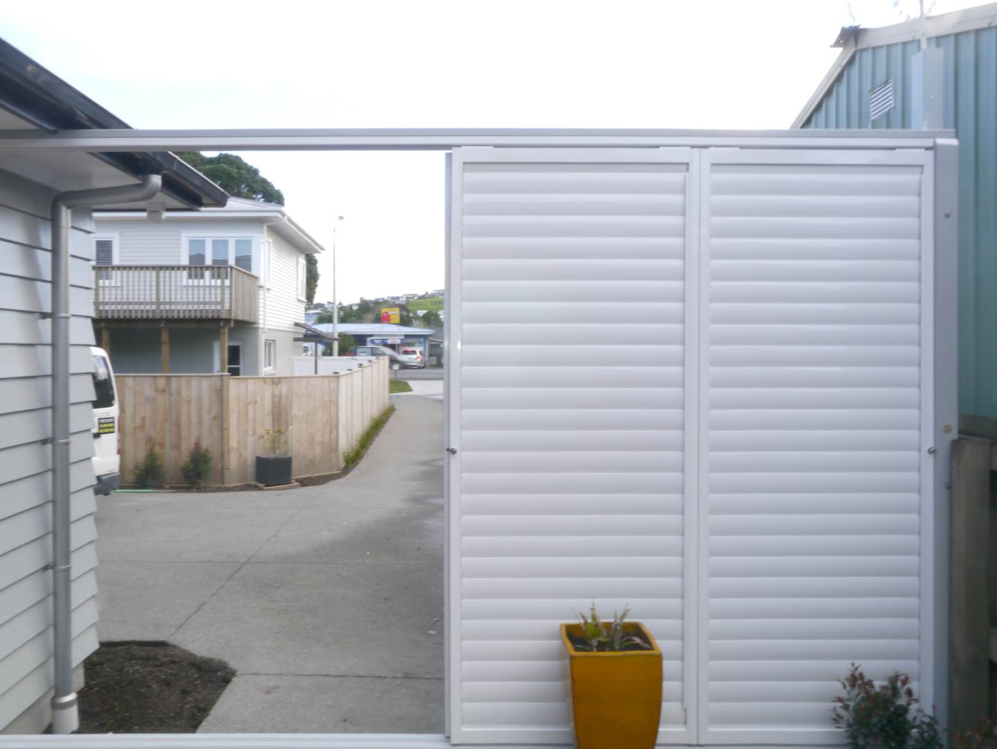 White fence and gate solution installed around home